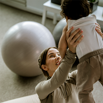 Strong woman holding her child in the air to recover mentally